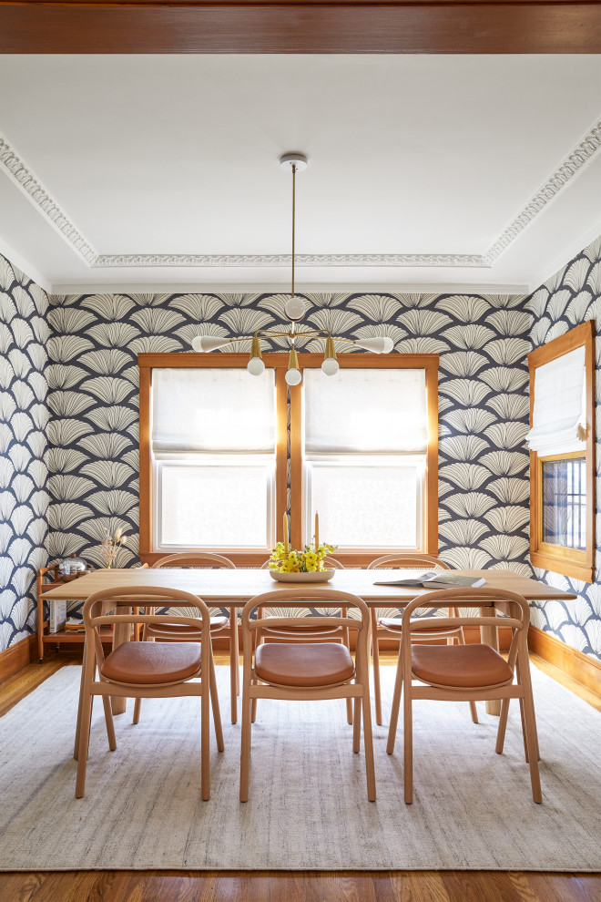 This is an example of a small traditional separate dining room in San Francisco with blue walls, medium hardwood floors, no fireplace, brown floor, coffered and wallpaper.
