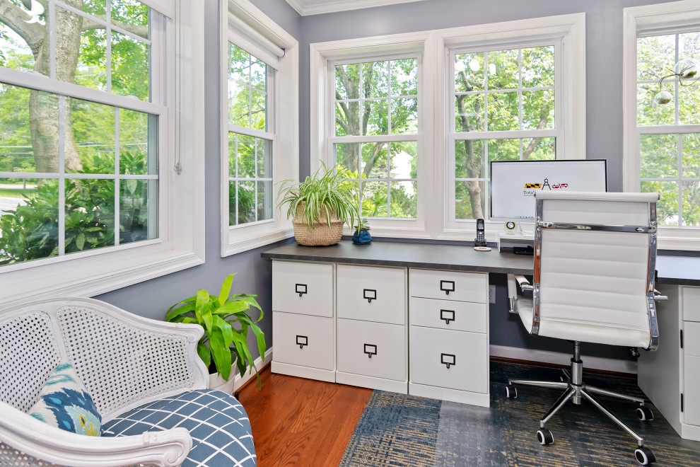 Photo of a small transitional home office in Baltimore with blue walls, medium hardwood floors and a freestanding desk.