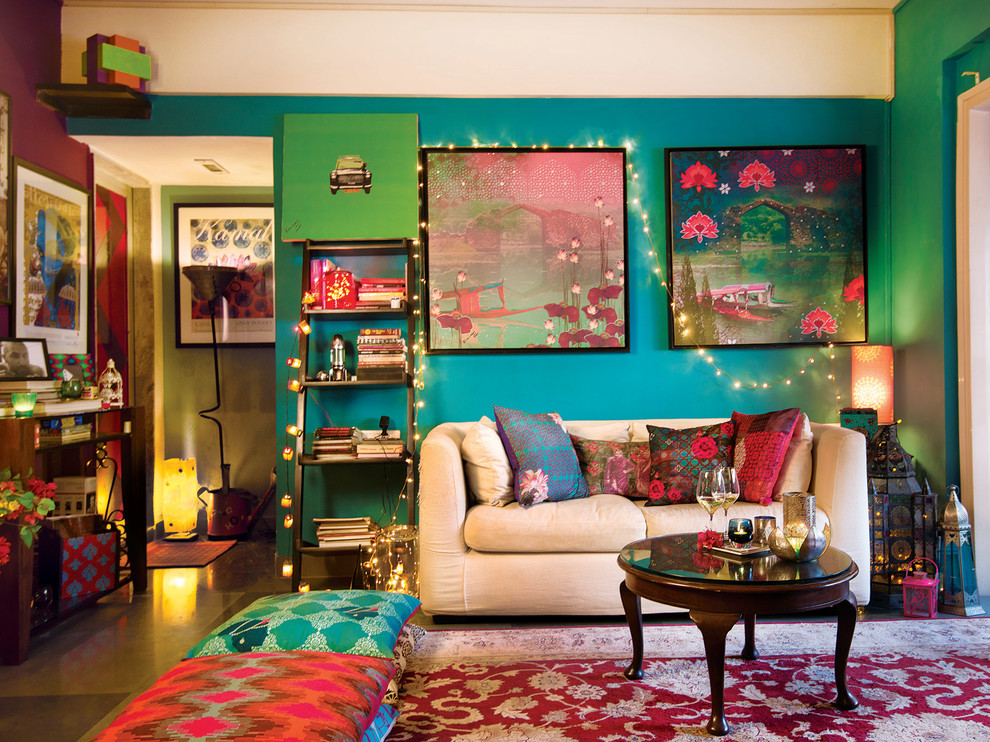 Mid-sized eclectic living room in Mumbai with no fireplace and blue walls.