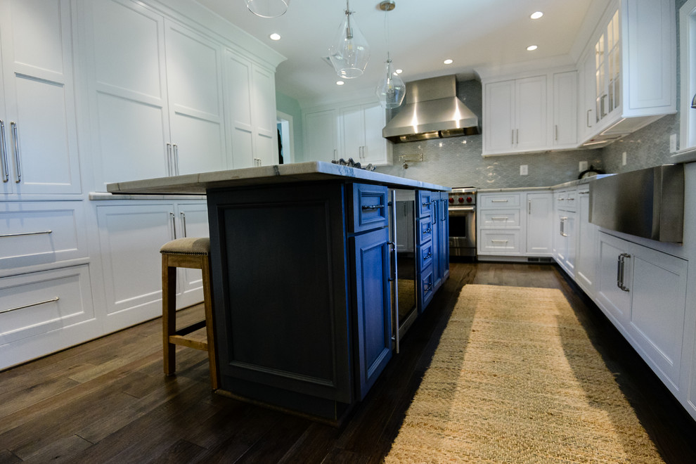 Eat-in kitchen - large transitional u-shaped medium tone wood floor and brown floor eat-in kitchen idea in DC Metro with a farmhouse sink, recessed-panel cabinets, white cabinets, marble countertops, stainless steel appliances, an island, gray backsplash and porcelain backsplash
