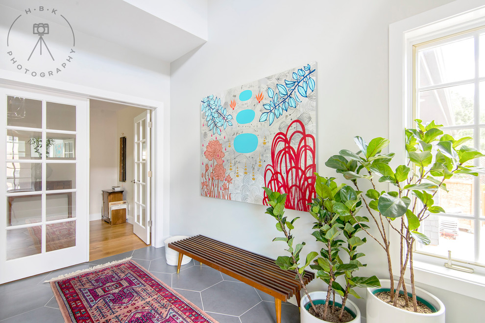 Inspiration for a mid-sized ceramic tile and gray floor foyer remodel with white walls