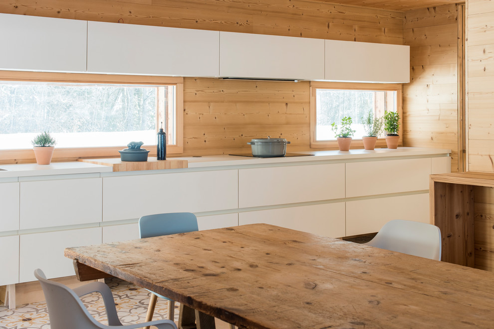 Design ideas for a mid-sized modern single-wall eat-in kitchen in Lyon with a double-bowl sink, flat-panel cabinets, white cabinets, beige splashback, timber splashback, ceramic floors and multi-coloured floor.