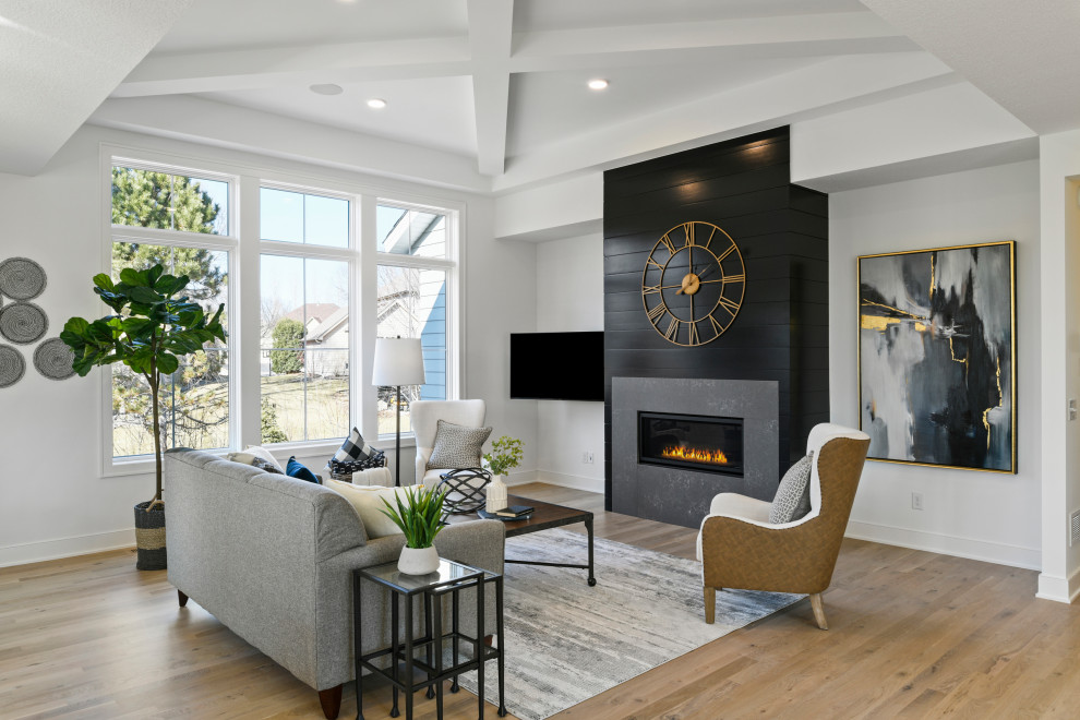 Inspiration for a large transitional formal open concept living room in Minneapolis with white walls, light hardwood floors, a ribbon fireplace, a wall-mounted tv and brown floor.