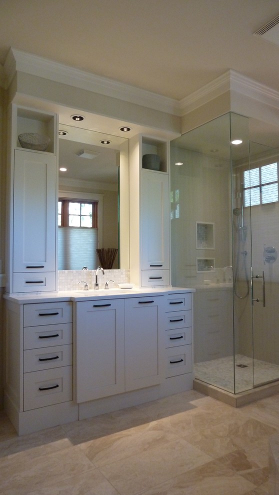 This is an example of a mid-sized arts and crafts master bathroom in Vancouver with shaker cabinets, white cabinets, an alcove tub, a curbless shower, porcelain tile, beige walls, porcelain floors, an undermount sink and marble benchtops.