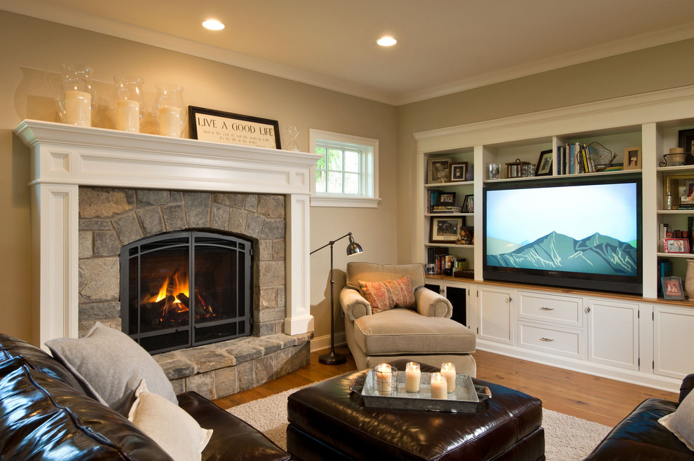 Photo of a traditional living room in New York with a standard fireplace, a stone fireplace surround and a built-in media wall.