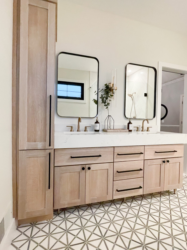 Photo of a medium sized contemporary ensuite bathroom in Detroit with shaker cabinets, light wood cabinets, a wall mounted toilet, white tiles, marble tiles, white walls, marble flooring, a submerged sink, engineered stone worktops, grey floors, a hinged door, white worktops, a shower bench, double sinks, a freestanding vanity unit and an alcove shower.