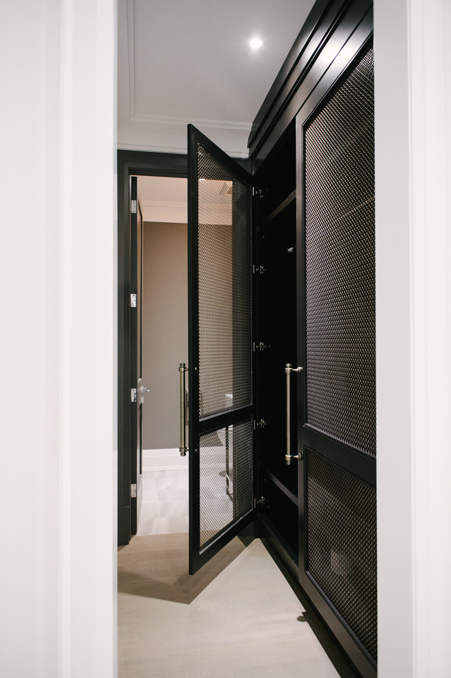 This is an example of a large contemporary hallway in Toronto with white walls, light hardwood floors and beige floor.