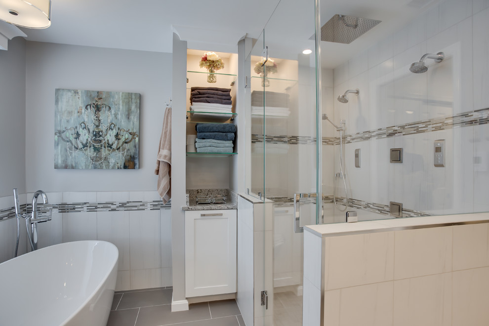 Design ideas for a large transitional master bathroom in DC Metro with shaker cabinets, white cabinets, a freestanding tub, an alcove shower, grey walls, an undermount sink, granite benchtops and grey floor.