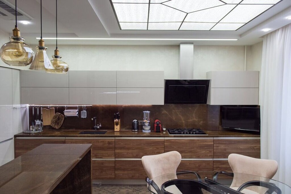 Photo of a mid-sized contemporary l-shaped eat-in kitchen in Moscow with an undermount sink, flat-panel cabinets, beige cabinets, marble benchtops, brown splashback, stainless steel appliances, porcelain floors and with island.