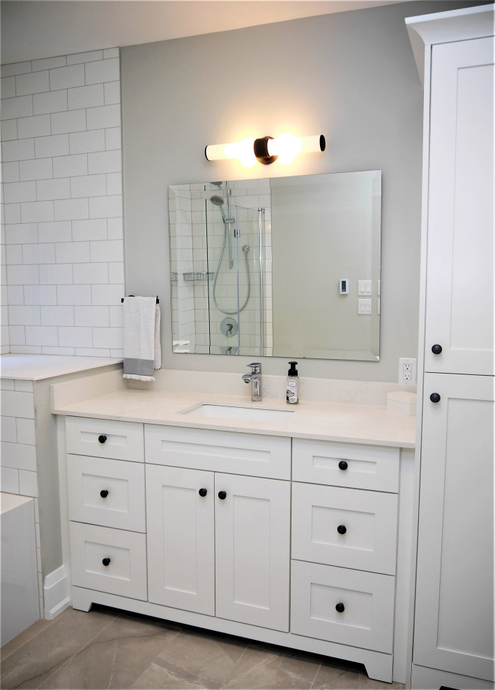 Alcove bathtub - mid-sized transitional white tile and porcelain tile single-sink alcove bathtub idea in Toronto with shaker cabinets, white cabinets, quartz countertops, white countertops and a built-in vanity