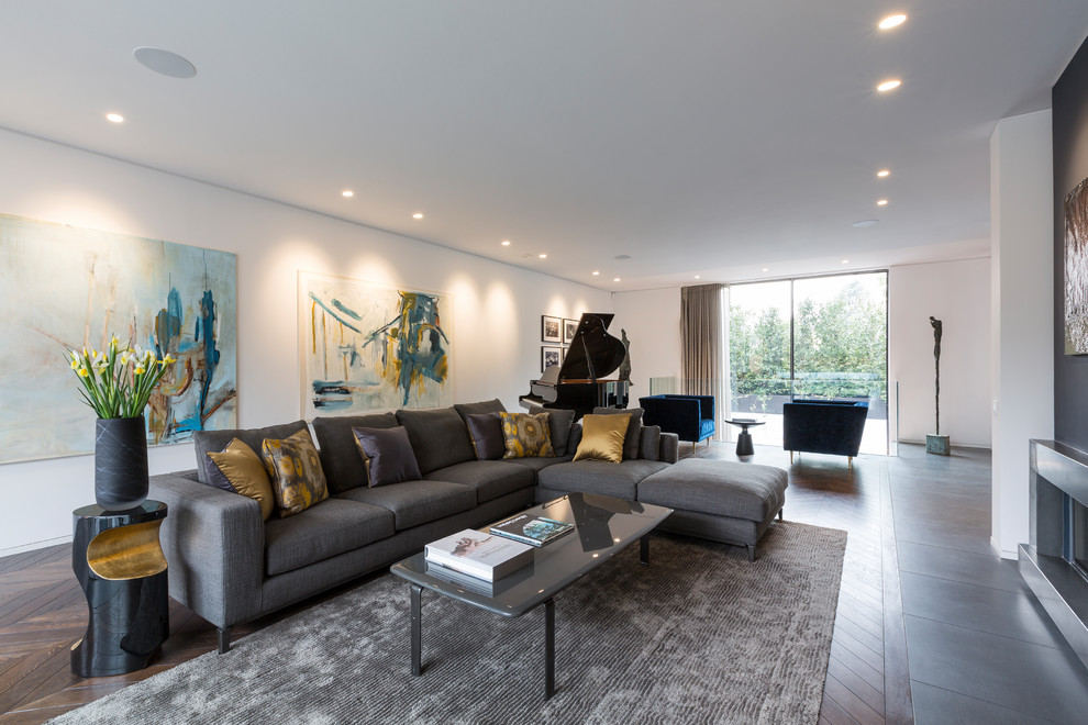 Photo of a large modern open concept living room in London with white walls, dark hardwood floors and brown floor.