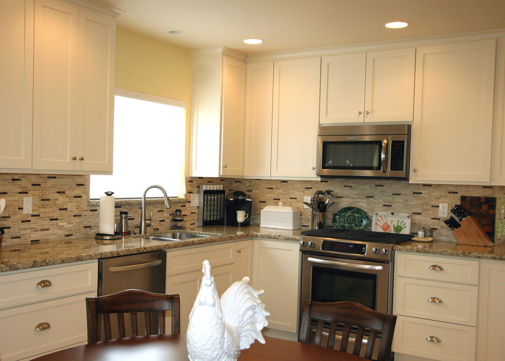 Mid-sized transitional single-wall ceramic tile eat-in kitchen photo with an undermount sink, shaker cabinets, white cabinets, granite countertops, beige backsplash, stone tile backsplash, stainless steel appliances and no island