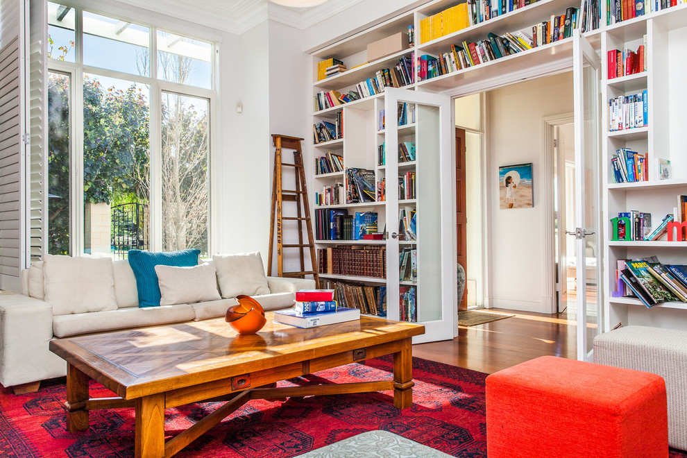 Inspiration for a contemporary enclosed living room in Perth with a library, white walls and medium hardwood floors.