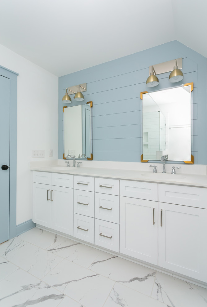 Design ideas for a mid-sized transitional master bathroom in Charleston with recessed-panel cabinets, white cabinets, white tile, subway tile, blue walls, ceramic floors, engineered quartz benchtops, white floor, a hinged shower door and white benchtops.