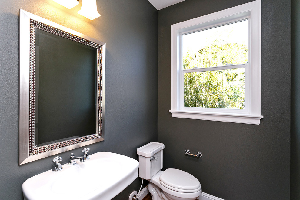 This is an example of a mid-sized arts and crafts 3/4 bathroom in Portland with a pedestal sink, recessed-panel cabinets, white cabinets, marble benchtops, gray tile, grey walls and porcelain floors.
