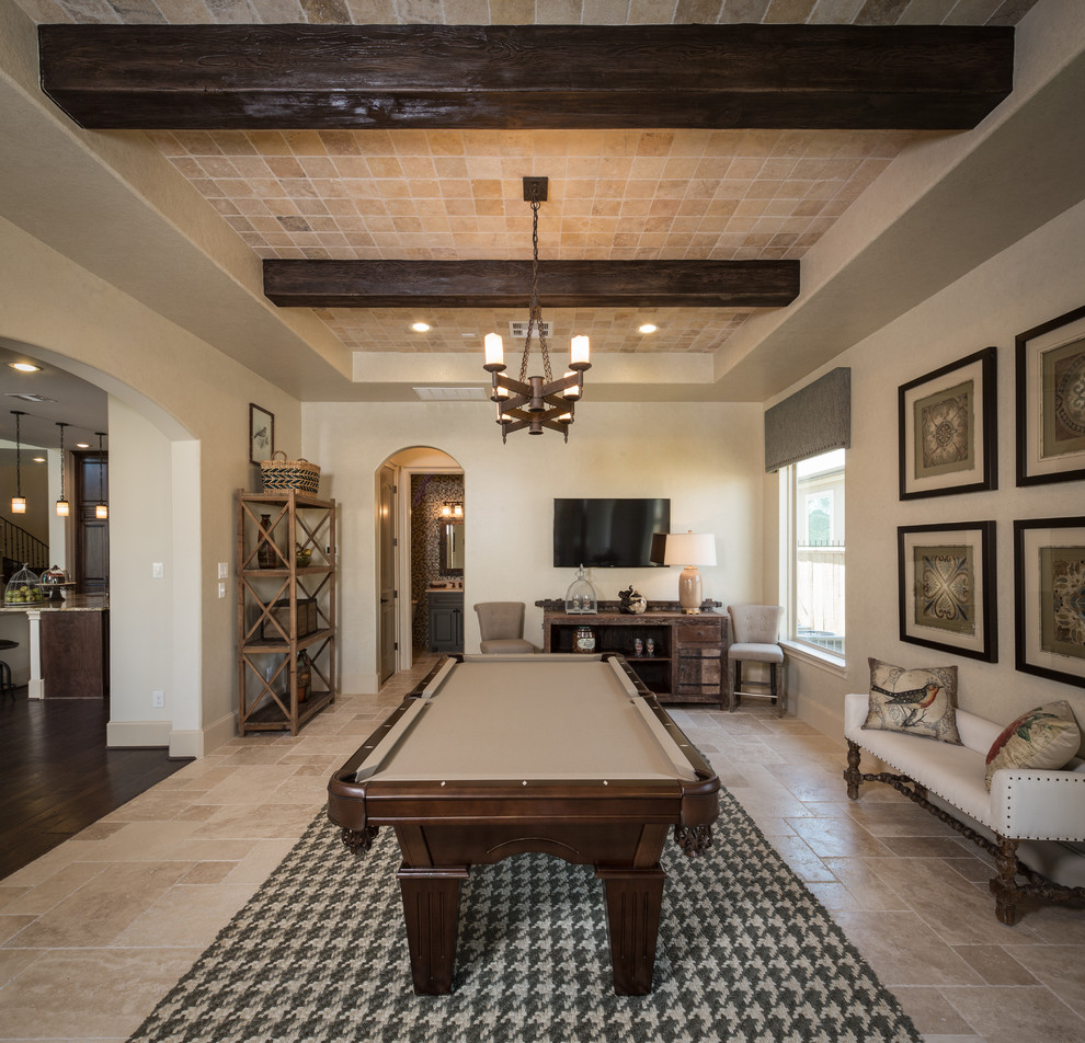 Photo of a mediterranean open concept family room in Houston with a game room, beige walls and a wall-mounted tv.