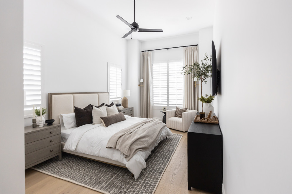 Worth the Wait - Example of a transitional light wood floor and beige floor bedroom design in Phoenix with white walls