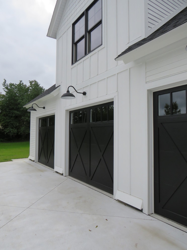 This is an example of a large country two-storey white exterior in Grand Rapids with wood siding.