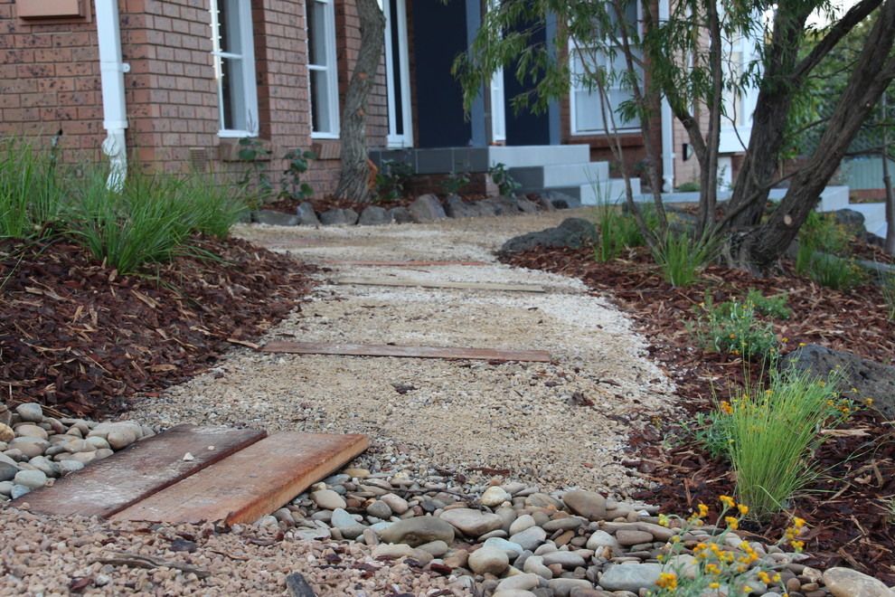 Design ideas for a small and australian native traditional front yard full sun garden for summer in Melbourne with a garden path and gravel.