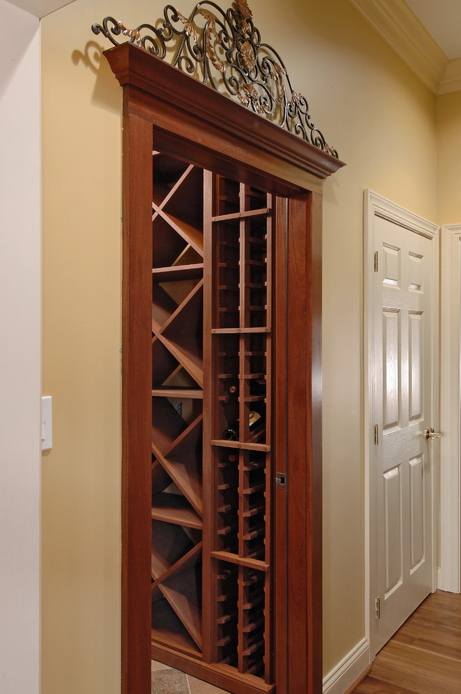 Photo of a mid-sized traditional wine cellar in DC Metro with medium hardwood floors and storage racks.