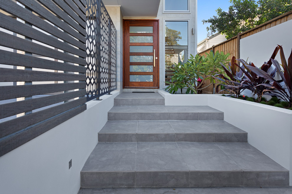 Inspiration for a large contemporary tile staircase in Brisbane with tile risers.