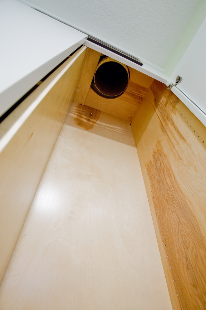 Example of a mid-sized transitional galley utility room design in Houston with flat-panel cabinets
