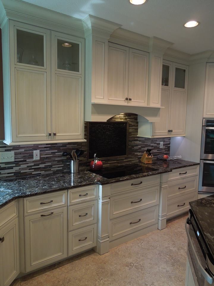Inspiration for a large l-shaped porcelain tile eat-in kitchen remodel with a double-bowl sink, beaded inset cabinets, white cabinets, marble countertops, brown backsplash, matchstick tile backsplash, stainless steel appliances and an island