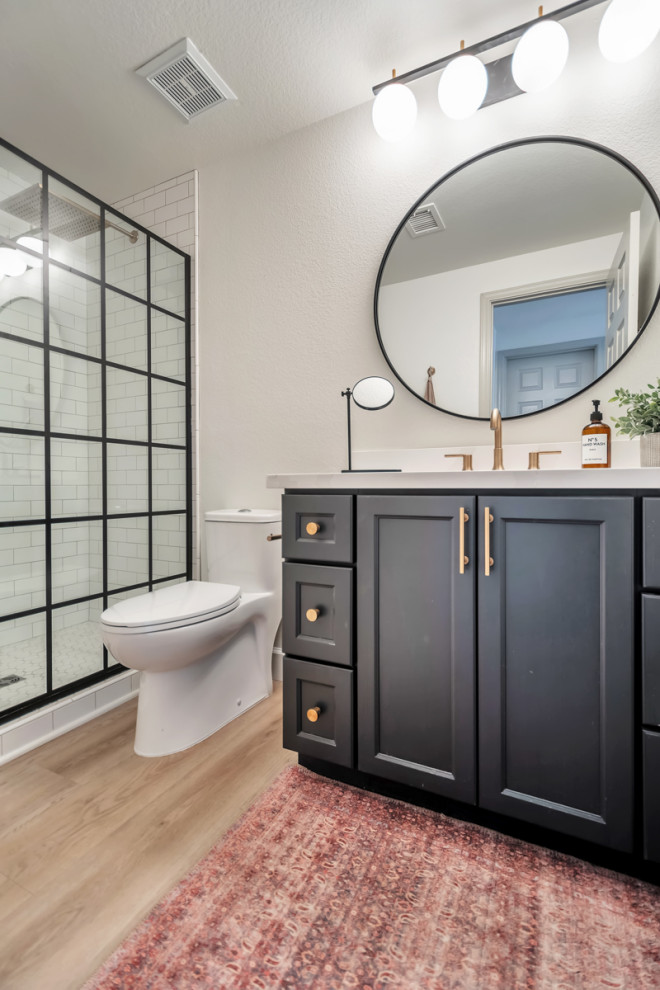 Small transitional 3/4 ceramic tile vinyl floor, brown floor and single-sink bathroom photo in Phoenix with shaker cabinets, black cabinets, an undermount sink, quartz countertops, white countertops, a niche and a built-in vanity