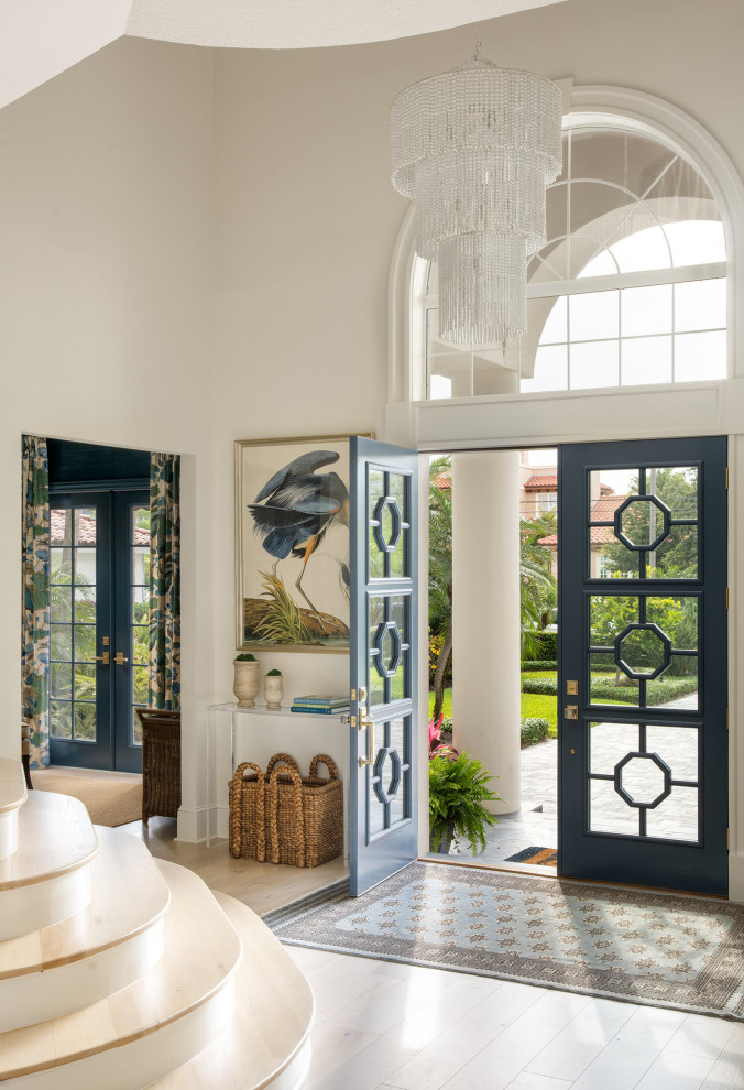 Inspiration for a mid-sized mediterranean front door in Tampa with marble floors, a double front door and a glass front door.