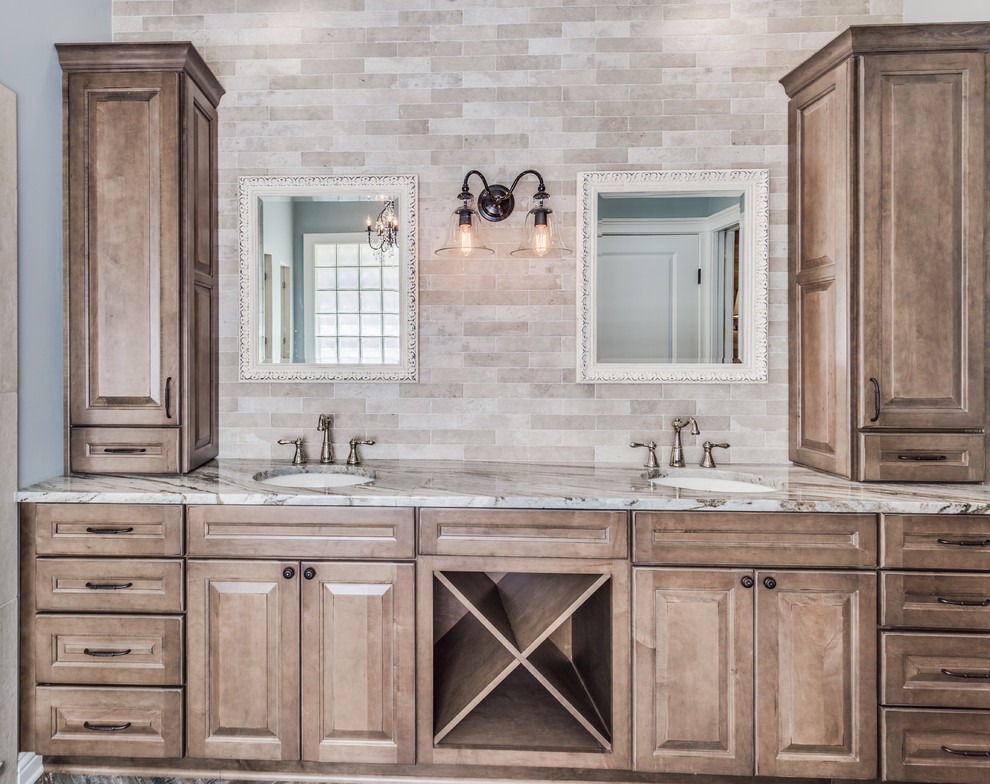 Photo of a country master bathroom in Jacksonville with raised-panel cabinets, medium wood cabinets, a claw-foot tub, an alcove shower, multi-coloured tile, porcelain tile, grey walls, porcelain floors, an undermount sink and marble benchtops.