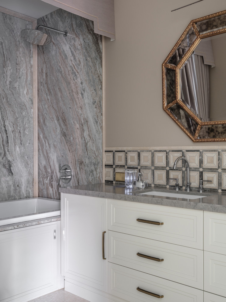 This is an example of a transitional master bathroom in Moscow with white cabinets, grey benchtops, recessed-panel cabinets, an alcove tub, a shower/bathtub combo, gray tile, beige walls, an undermount sink and a shower curtain.