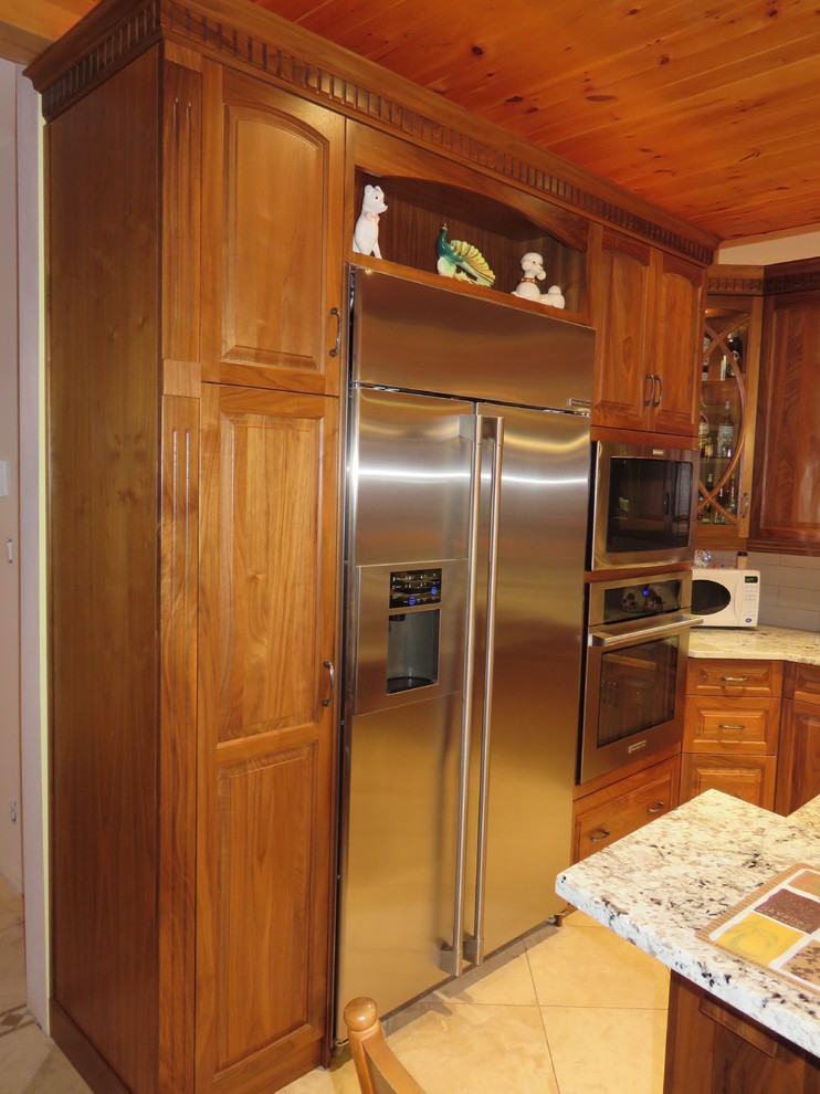 Open concept kitchen - large transitional l-shaped ceramic tile open concept kitchen idea with raised-panel cabinets, medium tone wood cabinets, granite countertops, stainless steel appliances, an island, a double-bowl sink, white backsplash and subway tile backsplash
