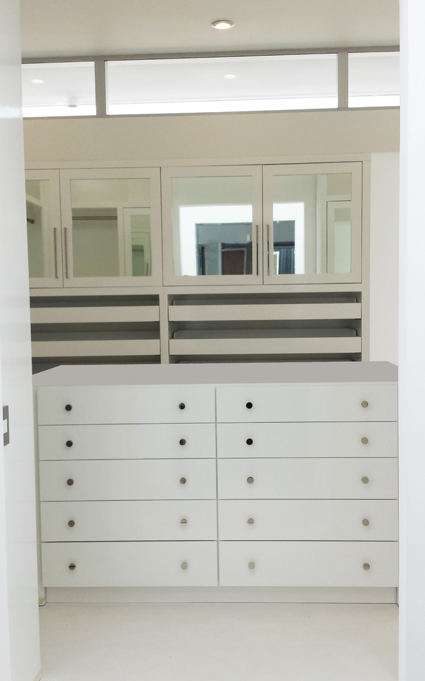 Design ideas for a mid-sized transitional gender-neutral walk-in wardrobe in Los Angeles with flat-panel cabinets, white cabinets and marble floors.
