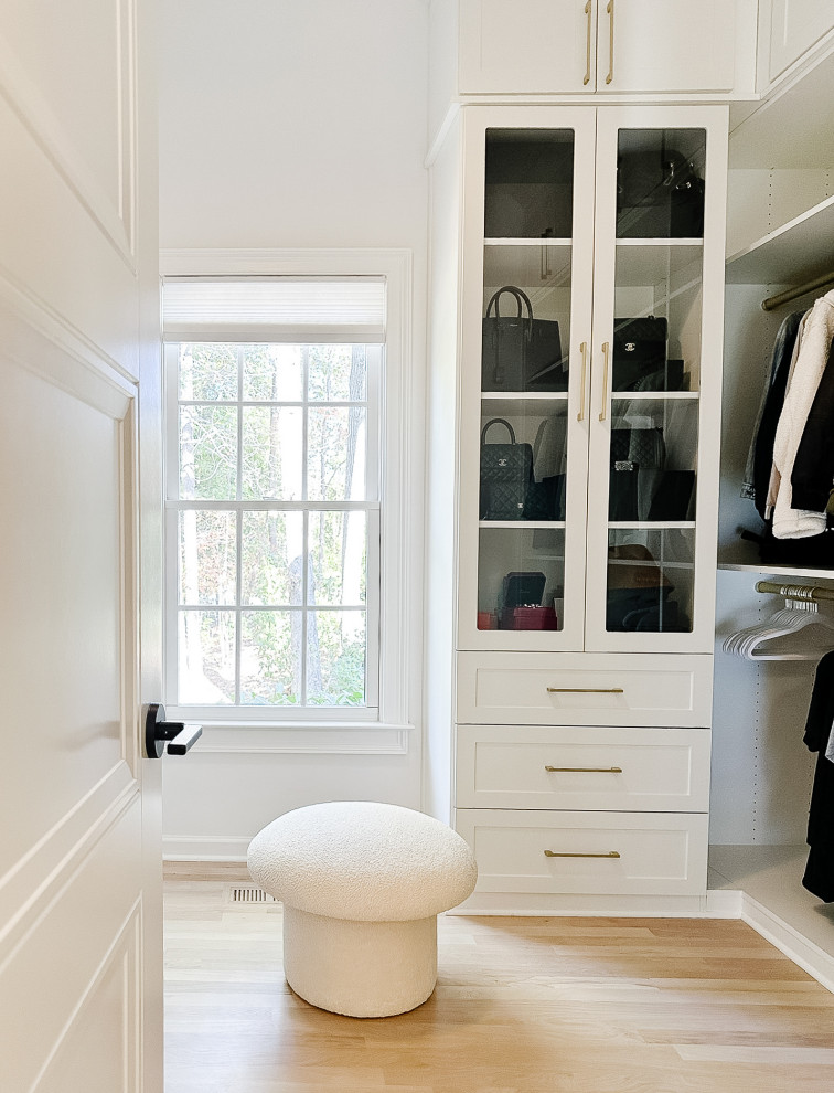 Diseño de armario y vestidor unisex minimalista grande con a medida, armarios estilo shaker, puertas de armario blancas, suelo de madera clara y suelo marrón
