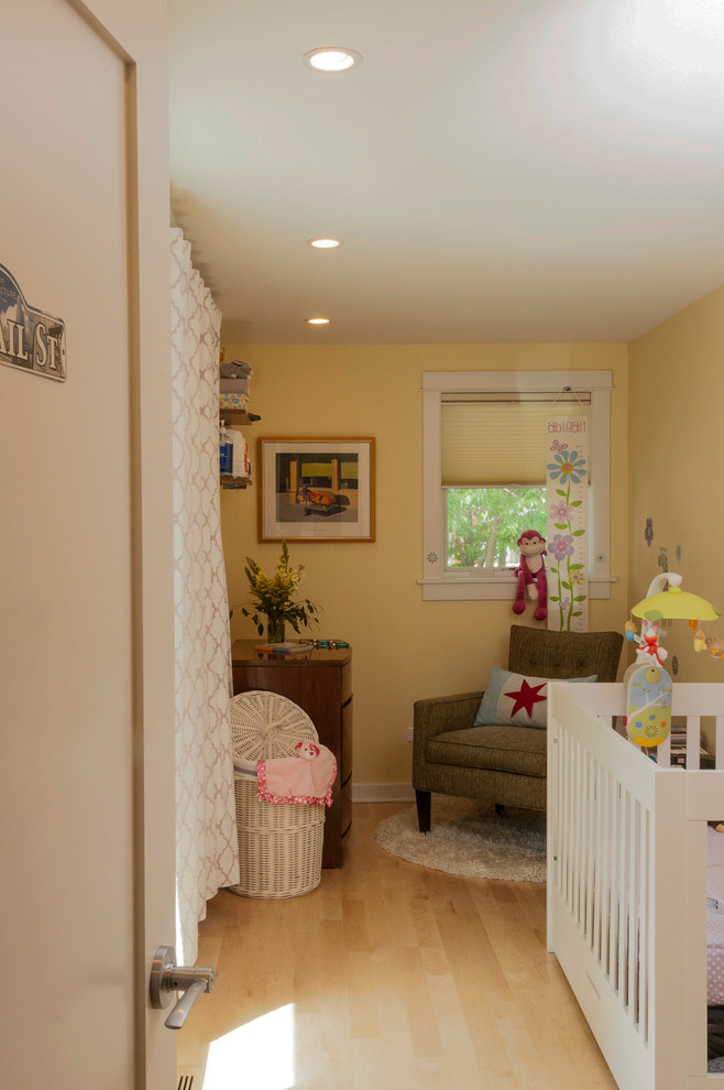 This is an example of a contemporary toddler room in Chicago with yellow walls.