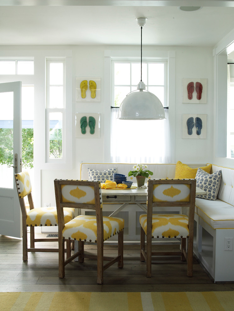 Photo of a beach style dining room in Jacksonville with white walls and medium hardwood floors.