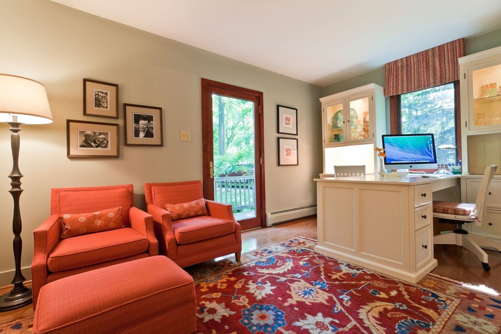 Photo of a mid-sized eclectic study room in Philadelphia with beige walls, light hardwood floors and a freestanding desk.