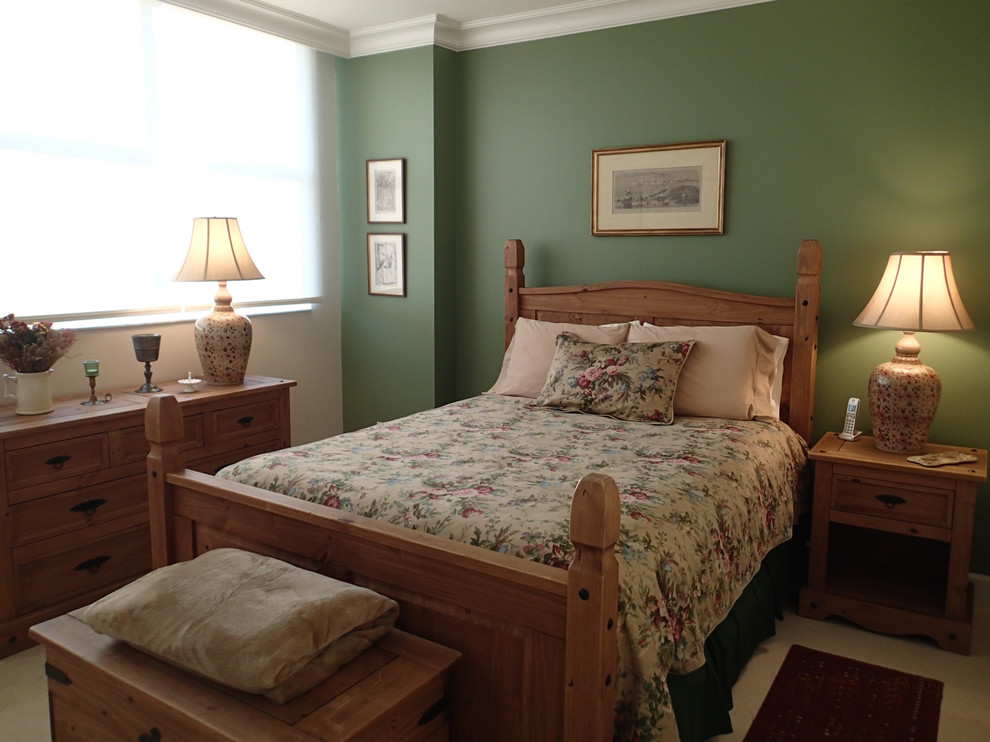 This is an example of a mid-sized country guest bedroom in Miami with green walls and no fireplace.