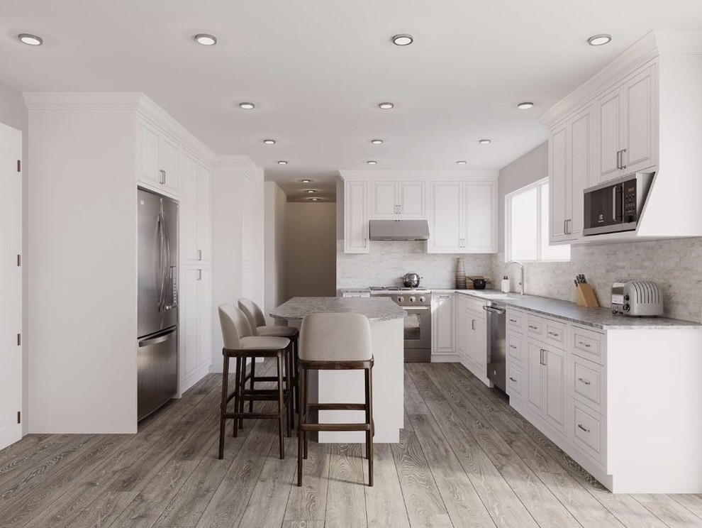 Inspiration for a mid-sized transitional l-shaped kitchen in San Francisco with an undermount sink, raised-panel cabinets, white cabinets, granite benchtops, grey splashback, stone tile splashback, stainless steel appliances, light hardwood floors, with island, grey floor and grey benchtop.