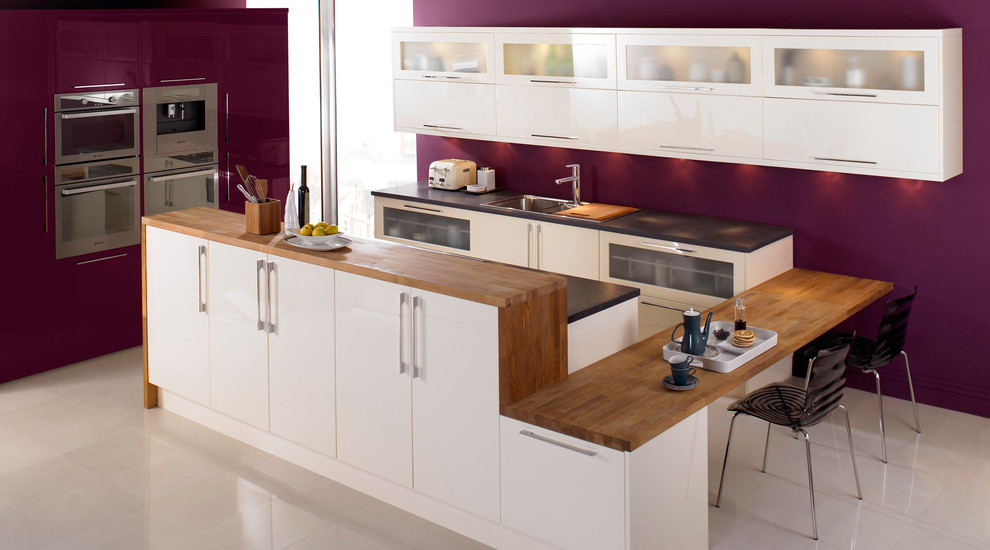 Inspiration for a contemporary kitchen in Hampshire with flat-panel cabinets, white cabinets and wood benchtops.