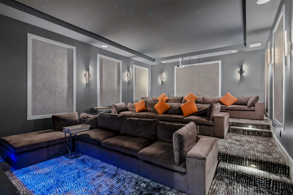 This is an example of a contemporary enclosed home theatre in Orlando with grey walls, carpet, a projector screen and grey floor.