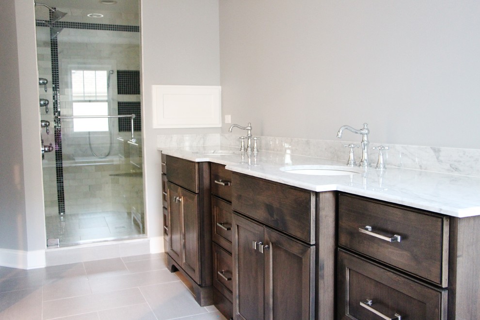 Design ideas for a mid-sized transitional master bathroom in Chicago with marble benchtops, a double shower, gray tile, subway tile, grey walls, porcelain floors, an undermount sink, furniture-like cabinets and dark wood cabinets.