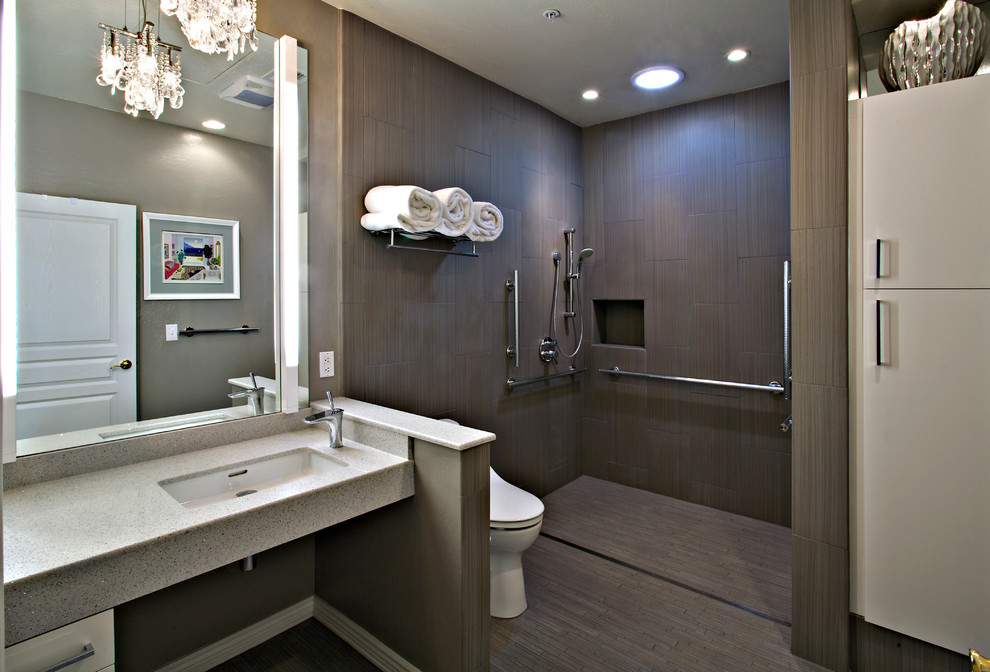 This is an example of a mid-sized contemporary master bathroom in Phoenix with an open shower, an open shower, brown floor, open cabinets, a one-piece toilet, brown walls, an undermount sink and terrazzo benchtops.