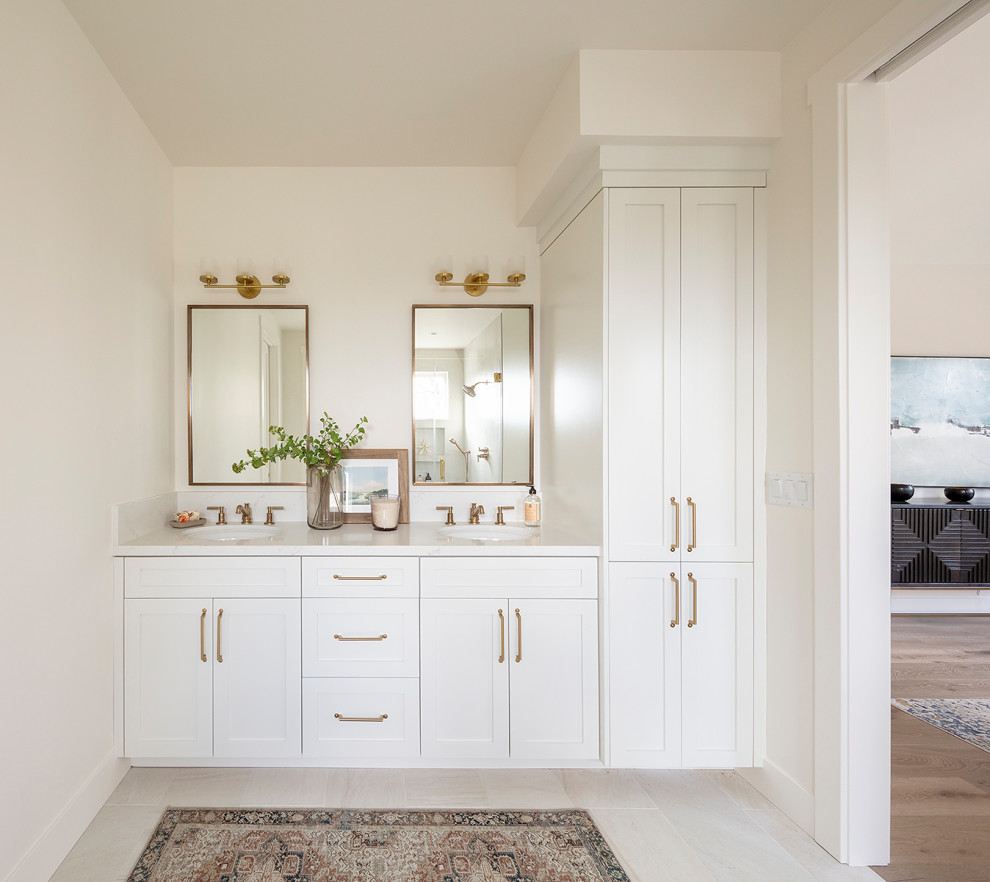 Example of a mid-sized country master white tile and ceramic tile porcelain tile, white floor and double-sink alcove shower design in San Francisco with shaker cabinets, white cabinets, a one-piece toilet, white walls, an undermount sink, quartz countertops, a hinged shower door, white countertops, a niche and a built-in vanity