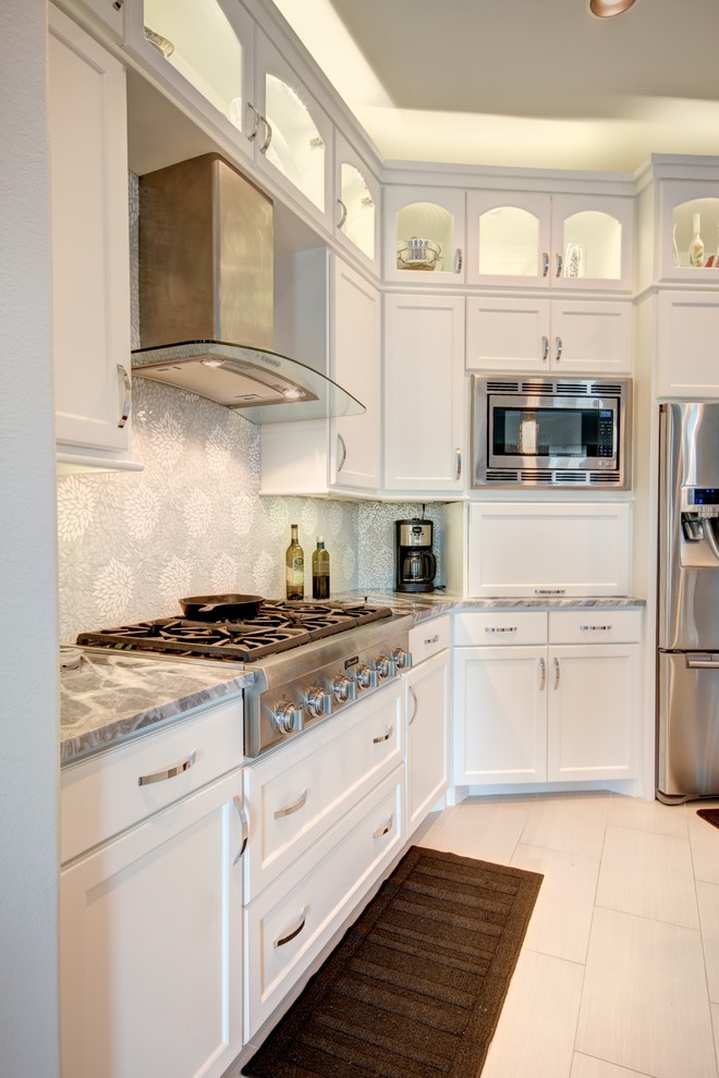Mid-sized transitional porcelain tile eat-in kitchen photo in Austin with an undermount sink, recessed-panel cabinets, white cabinets, marble countertops, gray backsplash, mosaic tile backsplash and stainless steel appliances