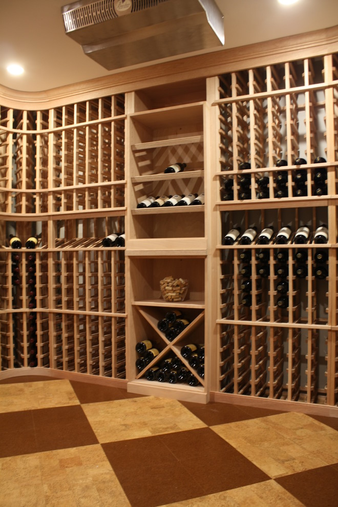 Design ideas for a mid-sized transitional wine cellar in Boston with cork floors and storage racks.
