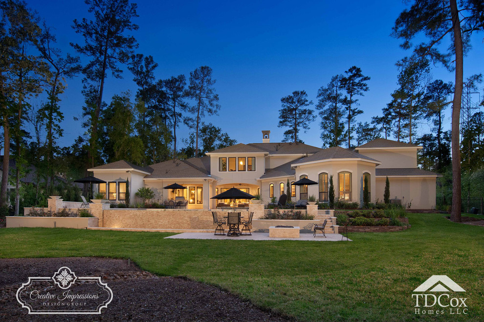Large transitional beige two-story stucco gable roof idea in Houston with a shingle roof