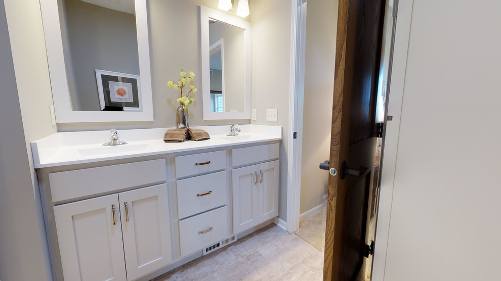 Mid-sized traditional master bathroom in Minneapolis with recessed-panel cabinets, grey cabinets, a two-piece toilet, grey walls, porcelain floors, a drop-in sink, engineered quartz benchtops, grey floor and white benchtops.