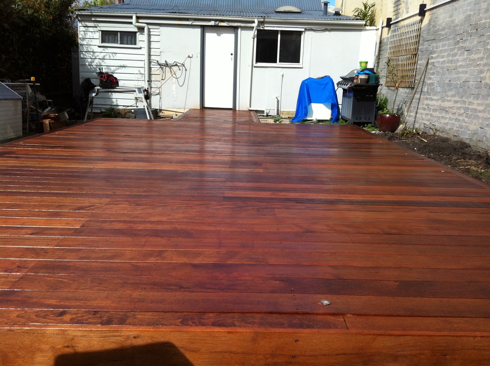 Design ideas for a mid-sized contemporary backyard deck in Melbourne with no cover.