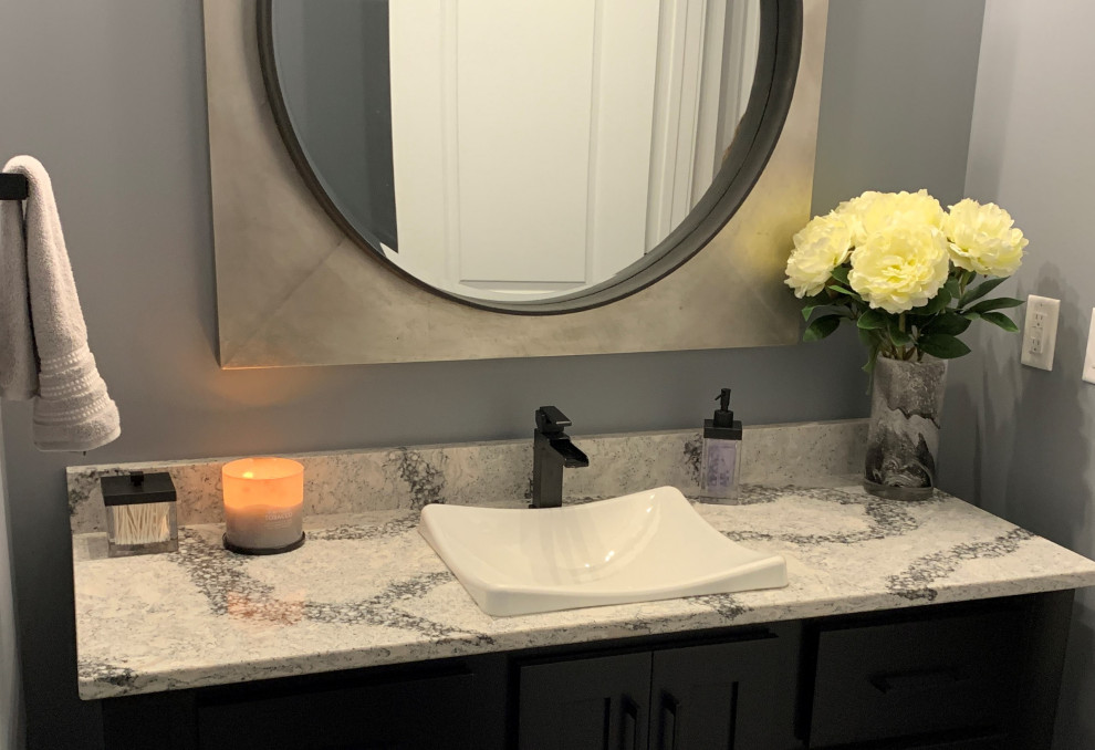 Photo of a mid-sized contemporary bathroom in Other with flat-panel cabinets, black cabinets, an alcove shower, black tile, porcelain tile, grey walls, a drop-in sink, engineered quartz benchtops, grey floor, an open shower, multi-coloured benchtops, a niche, a single vanity and a freestanding vanity.